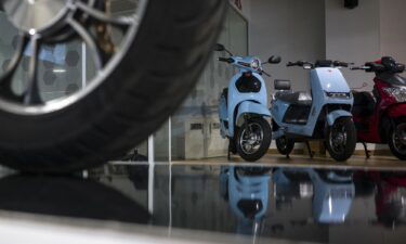 A man is pictured here charging an EV at a BluSmart charging hub in Gurugram