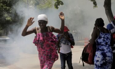 Haitians flee tear gas fired by officers clearing a camp of people at the US embassy seeking to escape the violence of armed gangs on July 25.