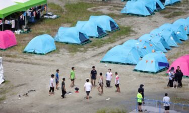 Participants at the World Scout Jamboree in South Korea cool down at a water supply zone on August 4.