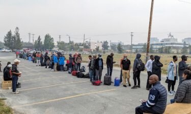 People line up in Yellowknife to register for an evacuation flight on August 17.