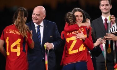 FIFA President Gianni Infantino (L) and Queen Letizia of Spain (2nd R) congratulate Spain's defender Laia Codina and forward Athenea del Castillo.