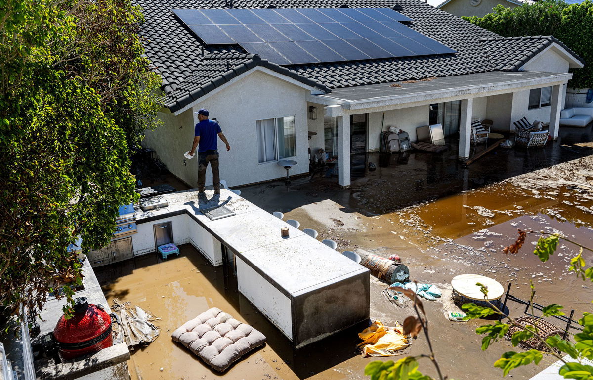 <i>Mario Tama/Getty Images</i><br/>A car is partially submerged in floodwaters as Tropical Storm Hilary moves through the area on August 20 in Cathedral City