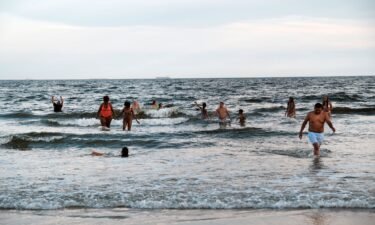 People spend a late afternoon at Rockaway Beach in the New York City borough of Queens on August 5.  A woman was transported to a hospital Monday after suffering an apparent shark bite near a beach in Queens.