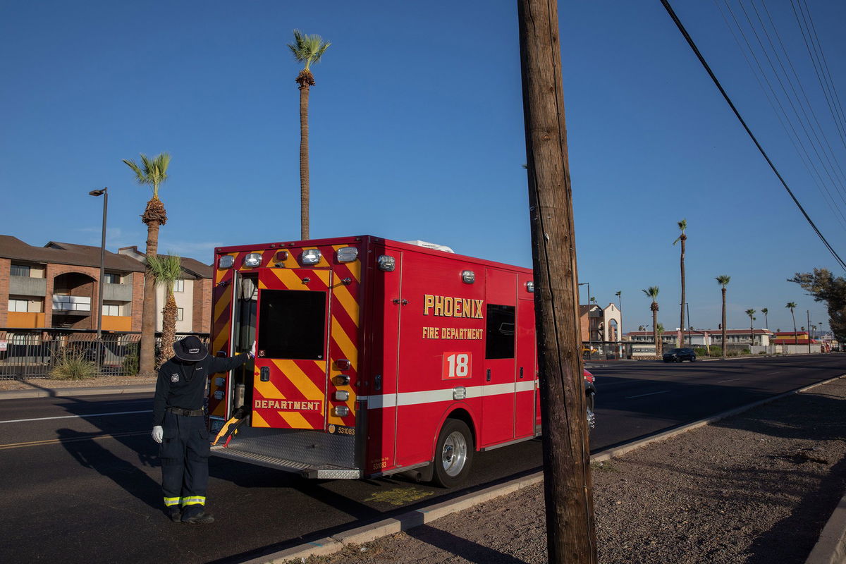 <i>Caitlin O'Hara/Bloomberg/Getty Images</i><br/>Phoenix-area paramedic waits to transport a resident to the hospital during extreme heat on July 20.