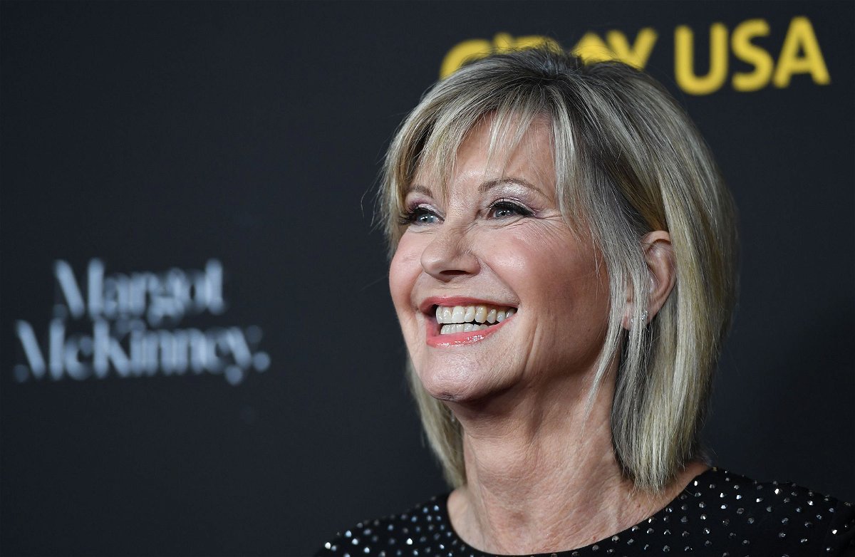 <i>Robyn Beck/AFP/Getty Images</i><br/>Olivia Newton-John’s husband and daughter say she’s visited them as a 