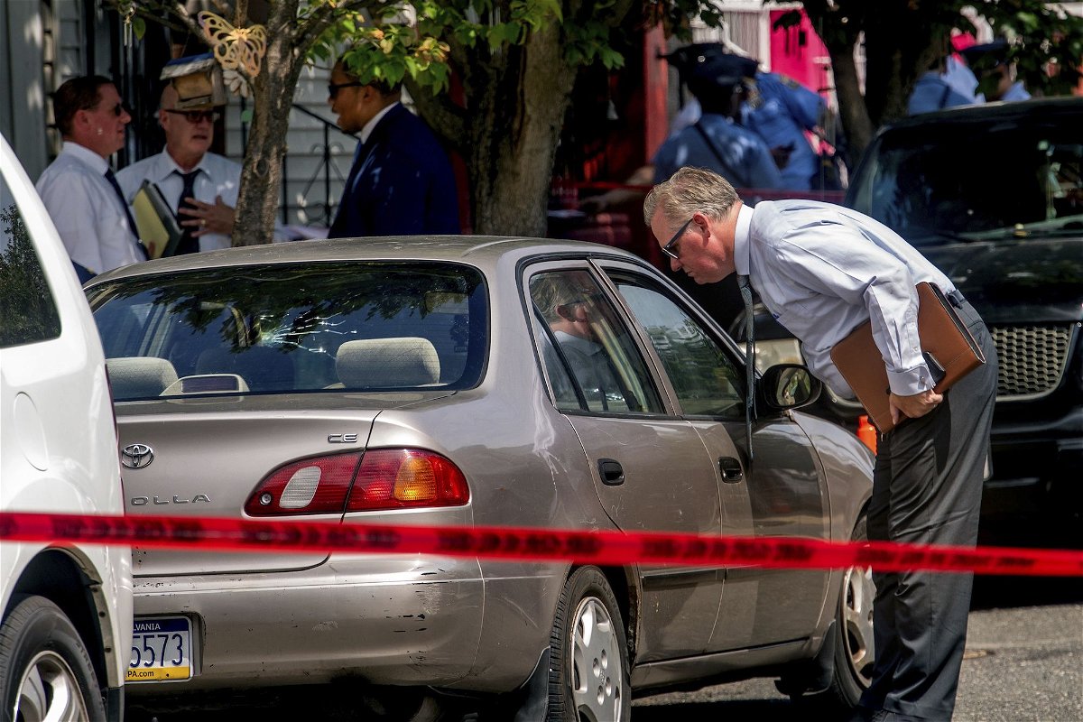 <i>Tom Gralish/The Philadelphia Inquirer/AP</i><br/>Authorities work the scene after a Philadelphia police officer fatally shot a man Monday.
