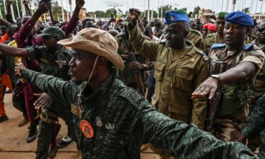 Niger's National Council for the Safeguard of the Homeland (CNSP) Colonel-Major Amadou Abdramane (2nd R) is greeted by supporters upon his arrival in Niamey on August 6.