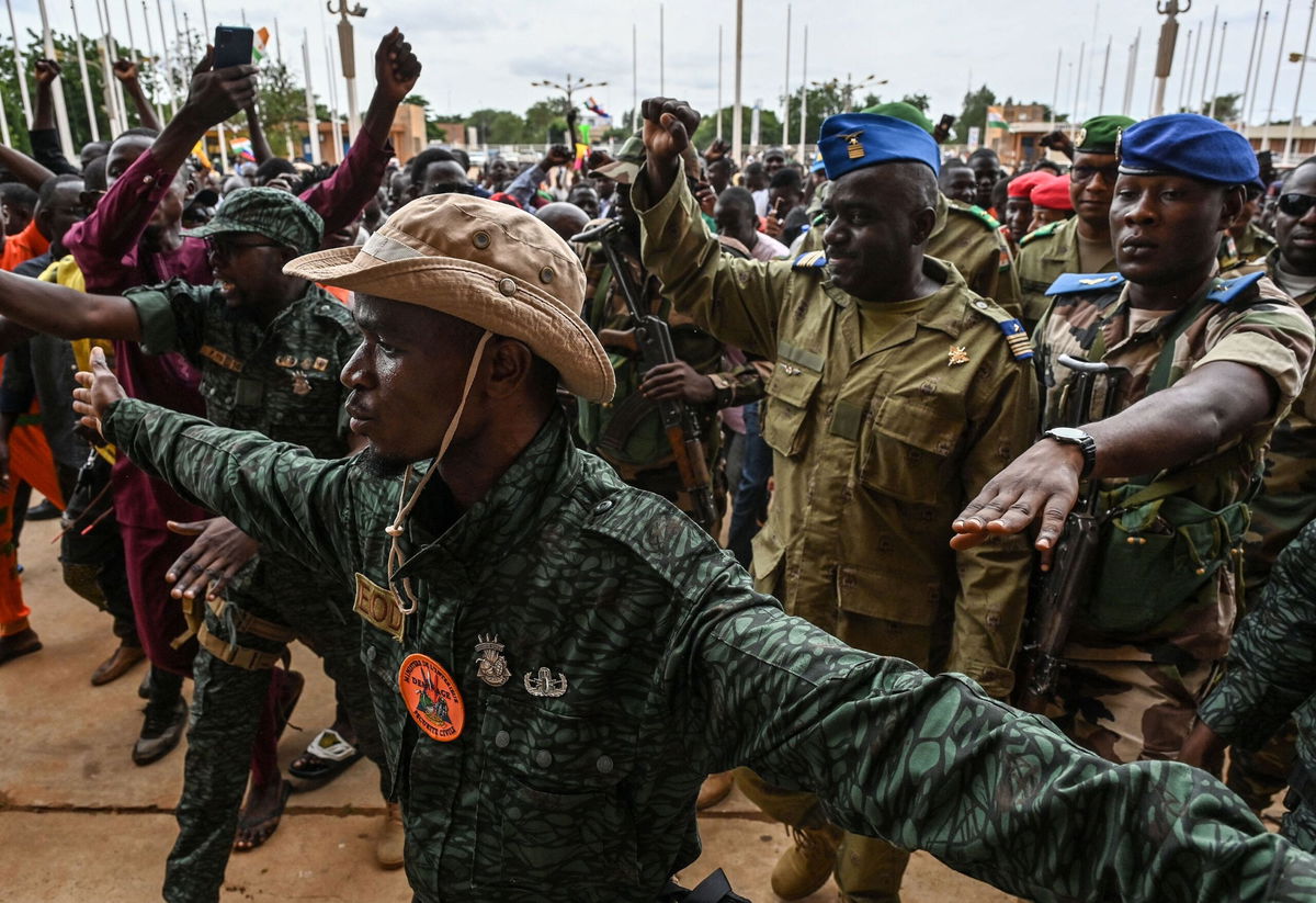 <i>AFP/Getty Images</i><br/>Niger's National Council for the Safeguard of the Homeland (CNSP) Colonel-Major Amadou Abdramane (2nd R) is greeted by supporters upon his arrival in Niamey on August 6.