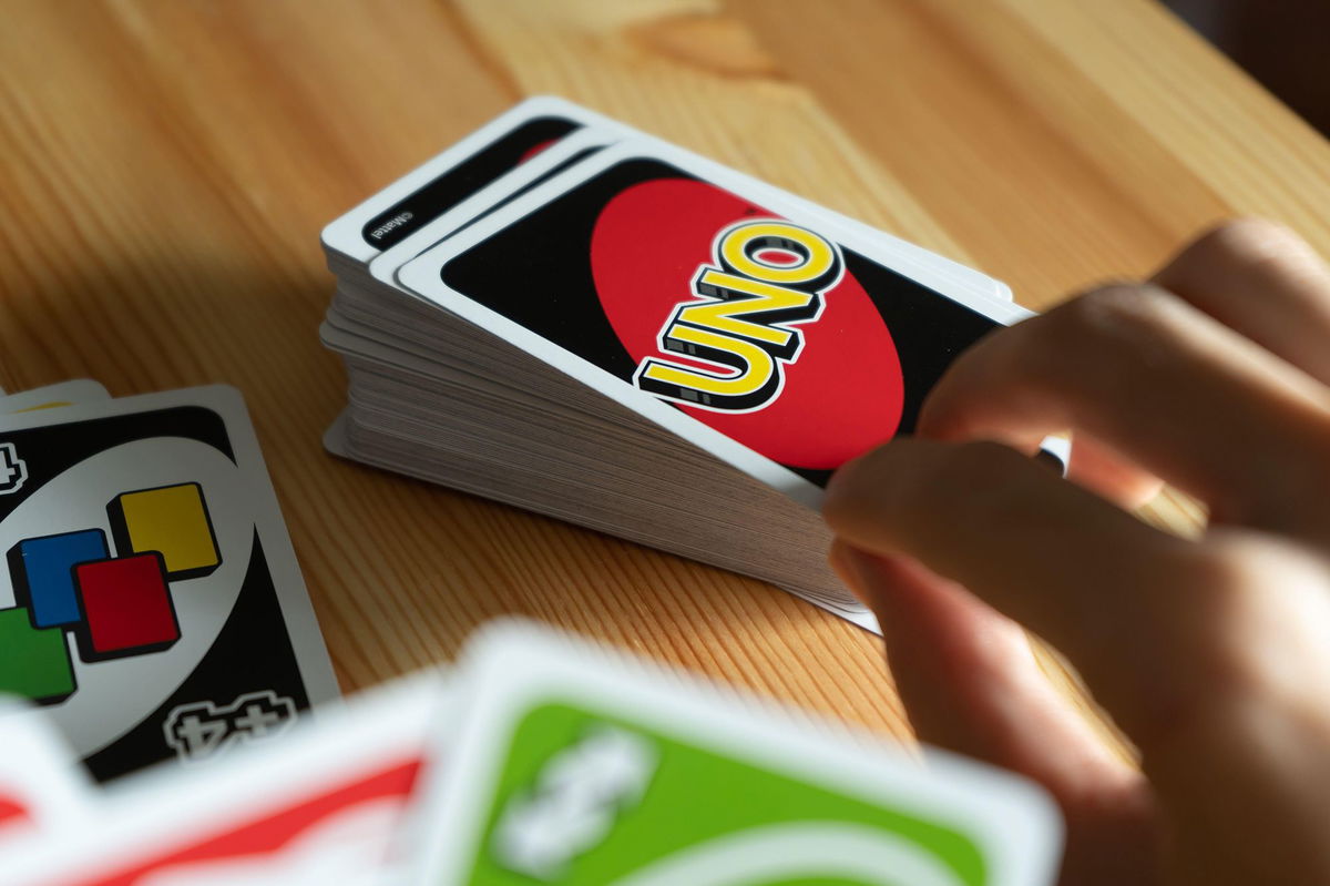 <i>Wachiwit/Alamy Stock Photo</i><br/>A person is seen playing UNO card game.