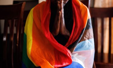 A member of the LGBTQ community prays during an evangelical church service on April 23