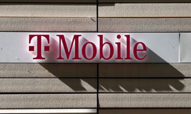 T-Mobile logo is seen on the building in Chicago. T-Mobile on August 24 announced it plans to lay off 5