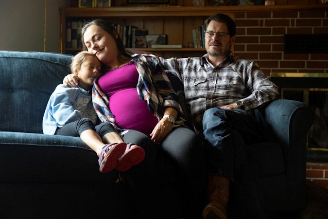 Alisha Alderson and her husband, Shane, sit with their daughter Adeline, 5, in the living room of their house in Baker City. Shane is Baker County's chief commission chair and Alisha is expecting their daughter, Ava, this month. Due to the closing of Baker City's only obstetrical unit, the family is traveling to the Boise area, a little over 100 miles away, to give birth