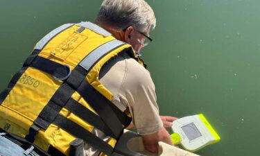 Casperson shows the handheld sonar at the Snake River.