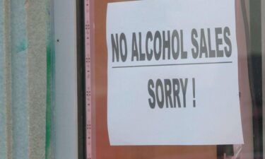 Rodney's Cigar and Liquor Store has "No Alcohol Sales Sorry!" sign on its front window.