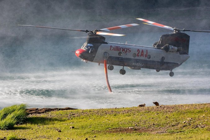 Helicopter refills with water to drop on the Lookout Fire
