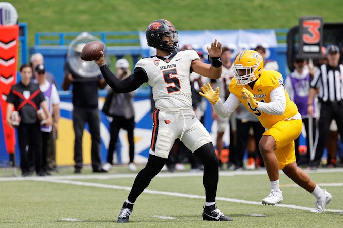 Oregon State quarterback DJ Uiagalelei (5) throws the ball as San Jose State defensive lineman Mata Hola (94) approaches in the first half of Sunday's game in San Jose