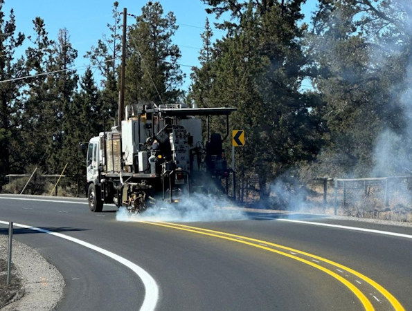 Pavement markings being applied on Old Bend-Redmond Hwy.