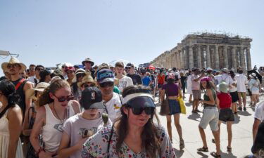 Pictured here: Tourists visit the Parthenon temple at the Athens' Acropolis during the July 2023 heatwave. Going forward