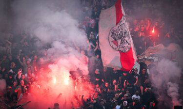 Police officers stand guard outside the stadium after the Eredivisie match was suspended.