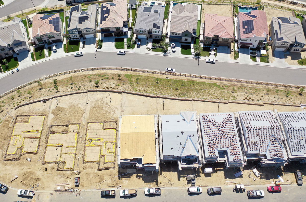 <i>Mario Tama/Getty Images</i><br/>An aerial view of existing homes near new homes under construction (BOTTOM) in the Chatsworth neighborhood on September 8 in Los Angeles