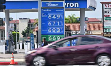 A sign displays the price of gas at more than 6 USD per gallon