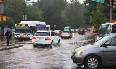 Cars drive through slight flooding on Ocean Avenue amid heavy rain on September 29 in the Flatbush neighborhood of Brooklyn borough New York City.