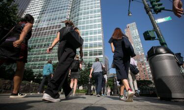 Pedestrians walk towards Goldman Sachs headquarters in New York