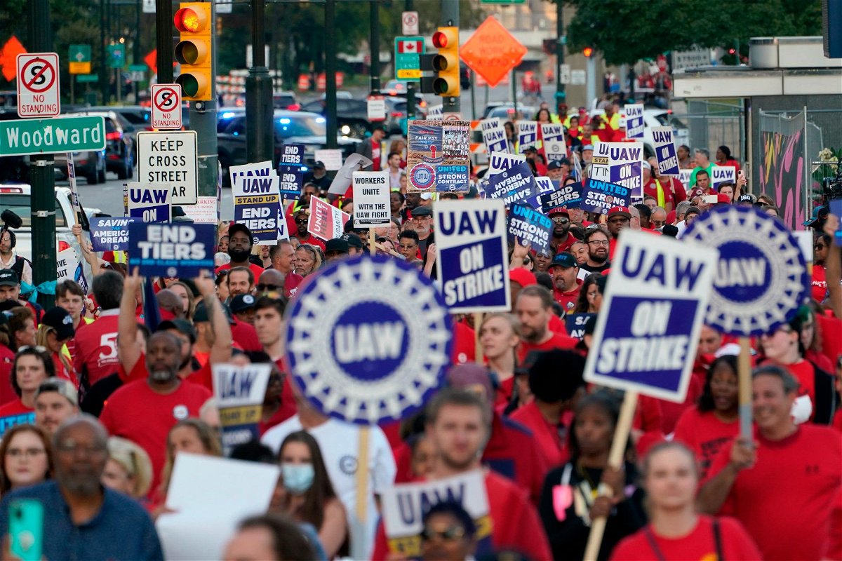 <i>Paul Sancya/AP</i><br/>United Auto Workers members march through downtown Detroit