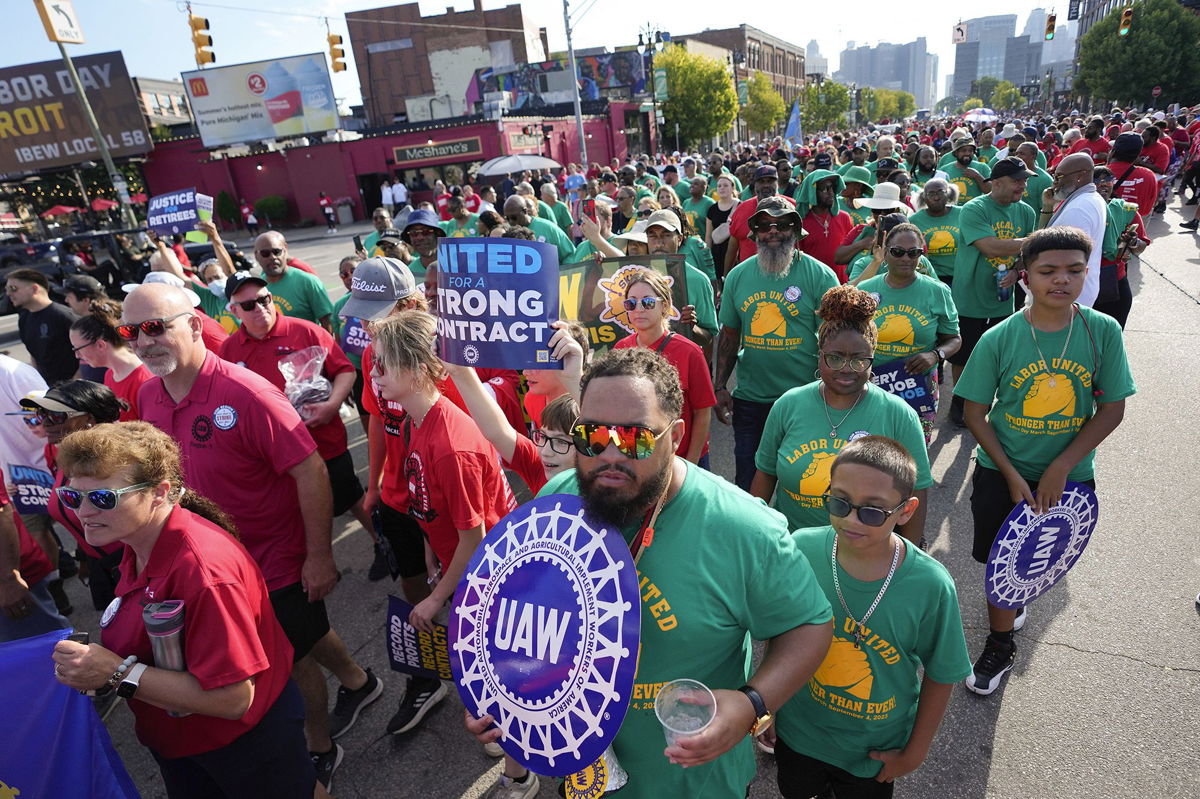 <i>Paul Sancya/AP</i><br/>United Auto Workers members walk in the Labor Day parade in Detroit on Sept. 4. Time is running out to avert a strike that could shut down America’s unionized auto assembly plants and other manufacturing facilities.
