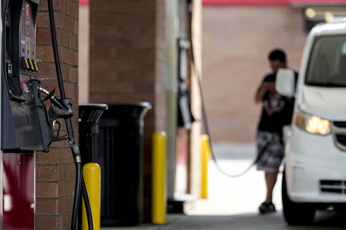 <i>Mike Stewart/AP</i><br/>A person pumps gas on Sept. 12 in Marietta