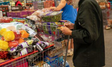 A person goes through a note pad while shopping for items at a Costco Wholesale store on September 6 in Colchester