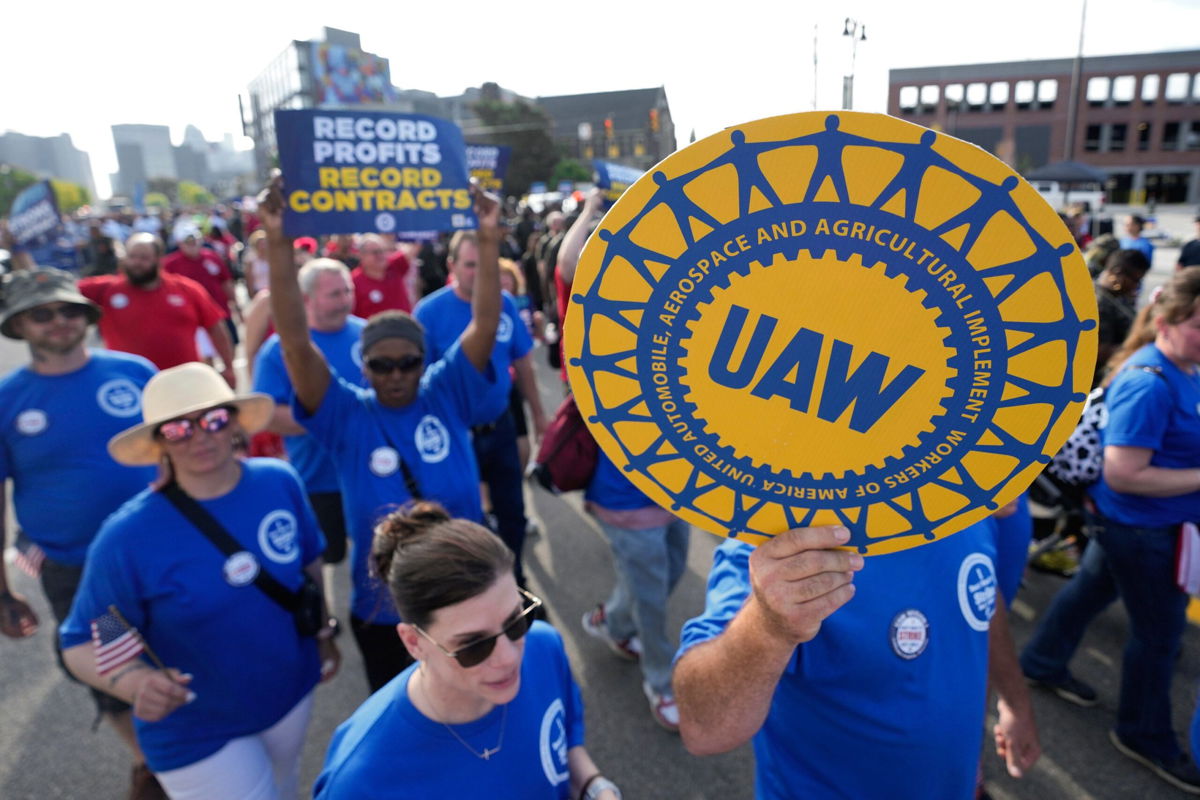 <i>Paul Sancya/AP</i><br/>United Auto Workers members walk in the Labor Day parade in Detroit