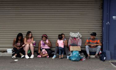 A group of Venezuelan migrants ask for money to continue their journey to the United States in San Jose