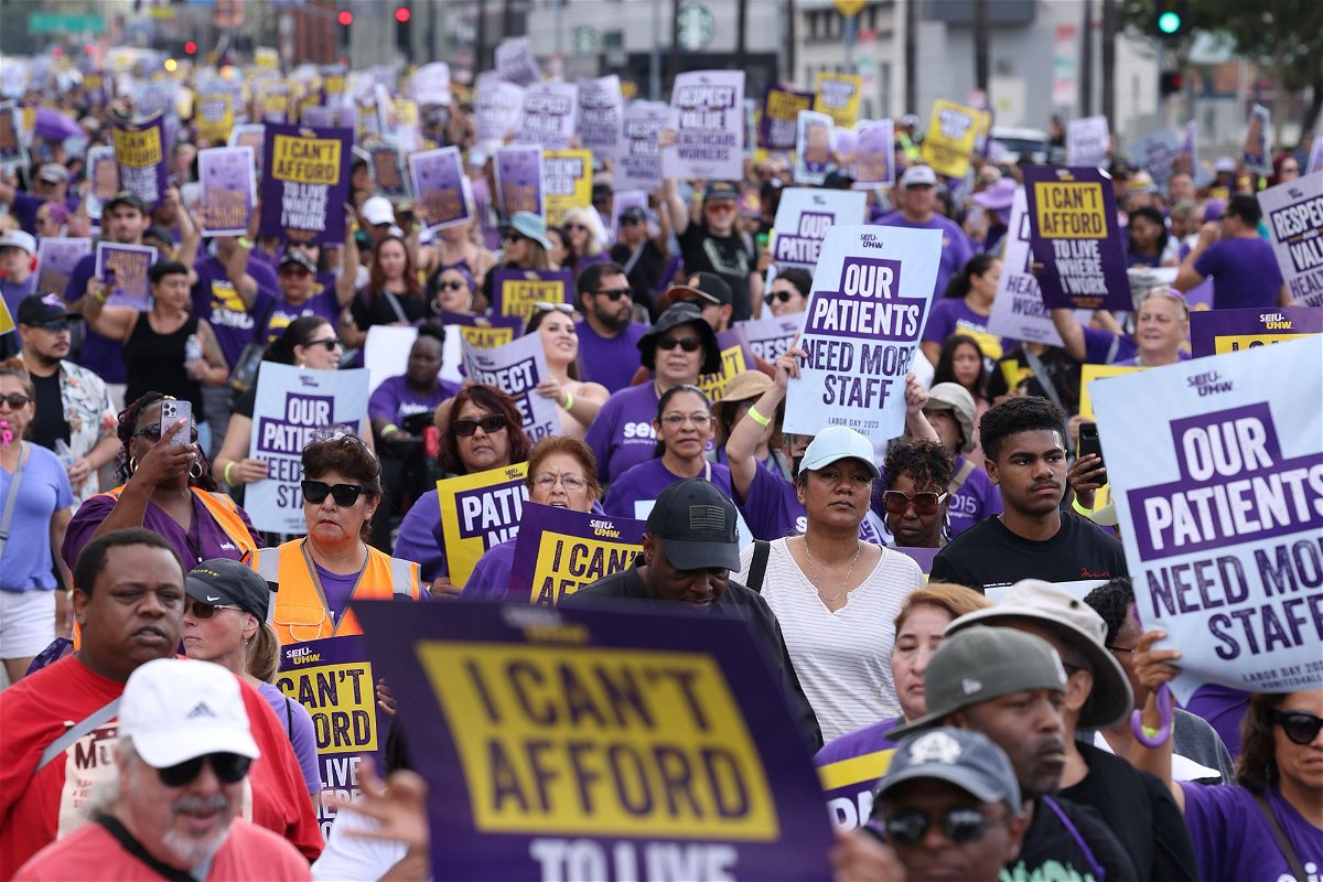 <i>Dania Maxwell/Los Angeles Times/Getty Images</i><br/>Healthcare workers take part in a rally at Kaiser Permanente's main medical facility in Kaiser P on Monday