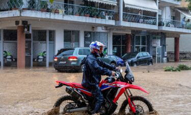 A man drives his bike in rising waters
