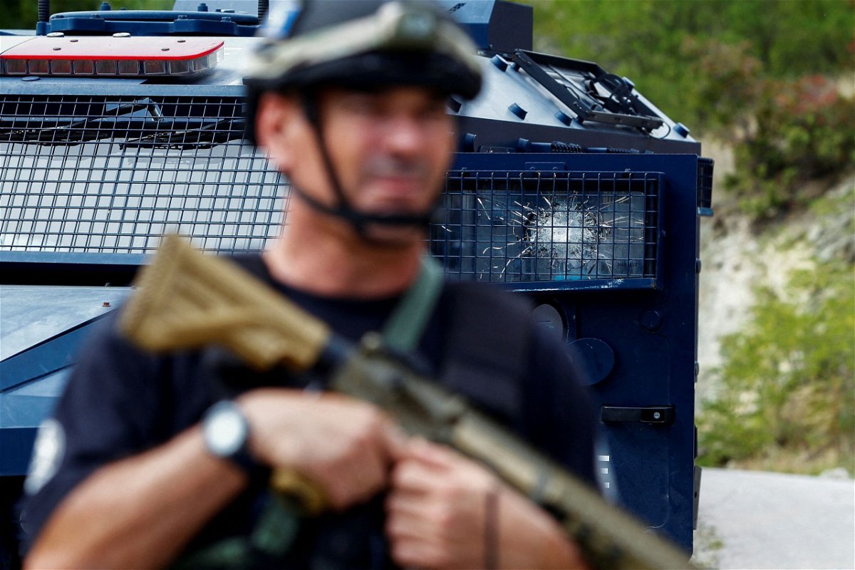 <i>Visar Kryeziu/AP</i><br/>Kosovo police officers display seized weapons and military equipment during the police operation in Banjska.