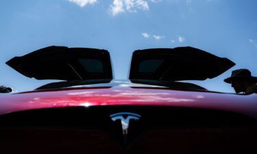 Attendees examine Tesla electric cars during the Electrify Expo In D.C. on July 23 in Washington