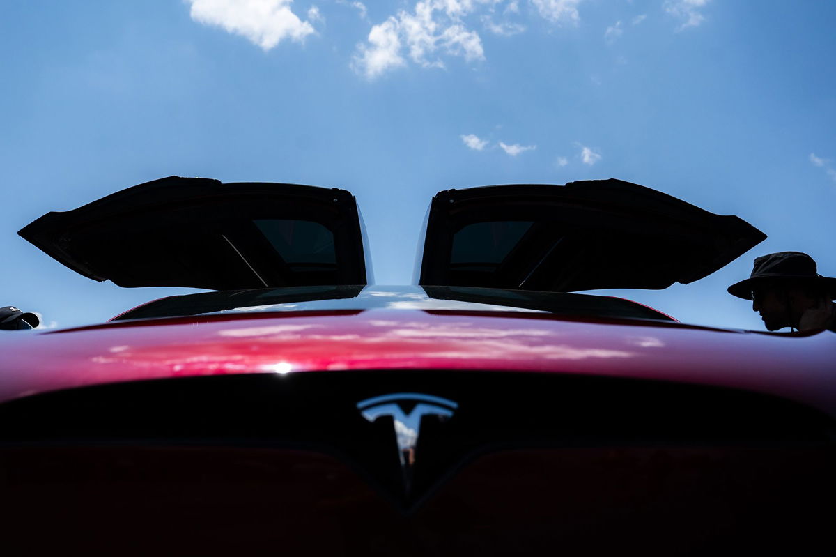 <i>Nathan Howard/Getty Images</i><br/>Attendees examine Tesla electric cars during the Electrify Expo In D.C. on July 23 in Washington