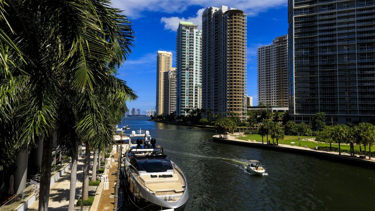 <i>Saul Martinez/Bloomberg/Getty Images</i><br/>A boat travels along the Miami River in downtown Miami in August 2022. The third Republican presidential primary debate will be held in Miami in early November.