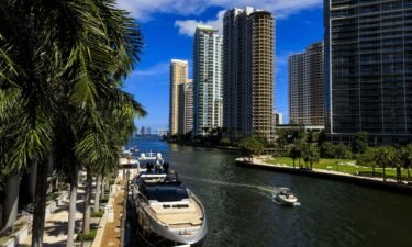 A boat travels along the Miami River in downtown Miami in August 2022. The third Republican presidential primary debate will be held in Miami in early November.