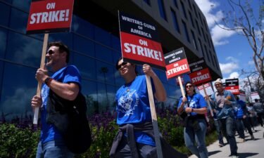 Striking Writers Guild of America workers picket outside the Sunset Bronson Studios building on May 2