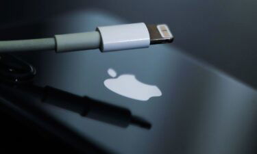 Lightning cable and Apple logo on iPhone are seen in this illustration photo taken in Krakow