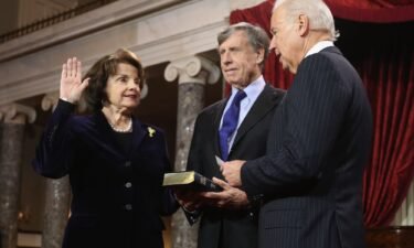 Sen. Dianne Feinstein participates in a reenacted swearing-in with her husband Richard Blum and Vice President Joe Biden on January 3