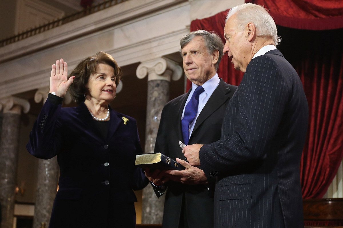 <i>Chip Somodevilla/Getty Images</i><br/>Sen. Dianne Feinstein participates in a reenacted swearing-in with her husband Richard Blum and Vice President Joe Biden on January 3