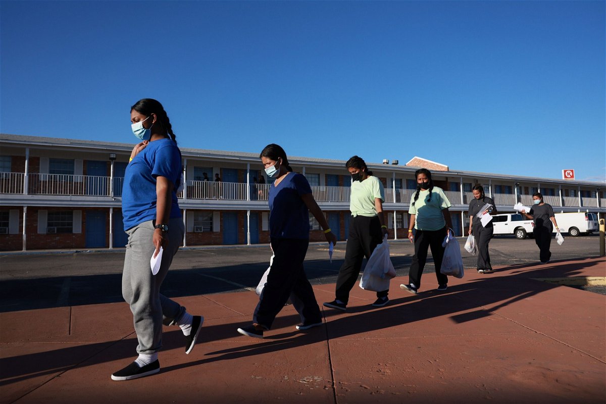 <i>Joe Raedle/Getty Images</i><br/>Migrants who recently arrived from Venezuela after crossing from Mexico are guided to a room at the hotel provided by the El Paso Office of Emergency Management in September 2022