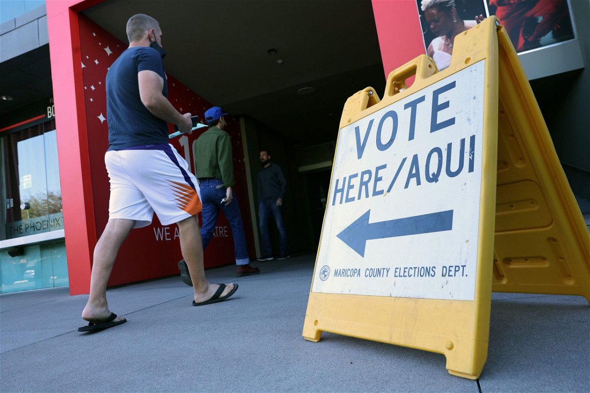 <i>Kevin Dietsch/Getty Images</i><br/>Voters arrive to cast their ballots at the Phoenix Art Museum on November 8