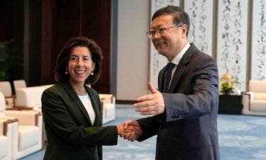 Shanghai Party Secretary Chen Jining (right) gestures as he shakes hands with US Commerce Secretary Gina Raimondo before a meeting in Shanghai on August 30.