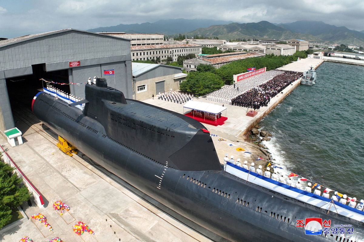 <i>KCNA/Reuters</i><br/>People attend what North Korean state media report was the country's launching ceremony for a new tactical nuclear attack submarine