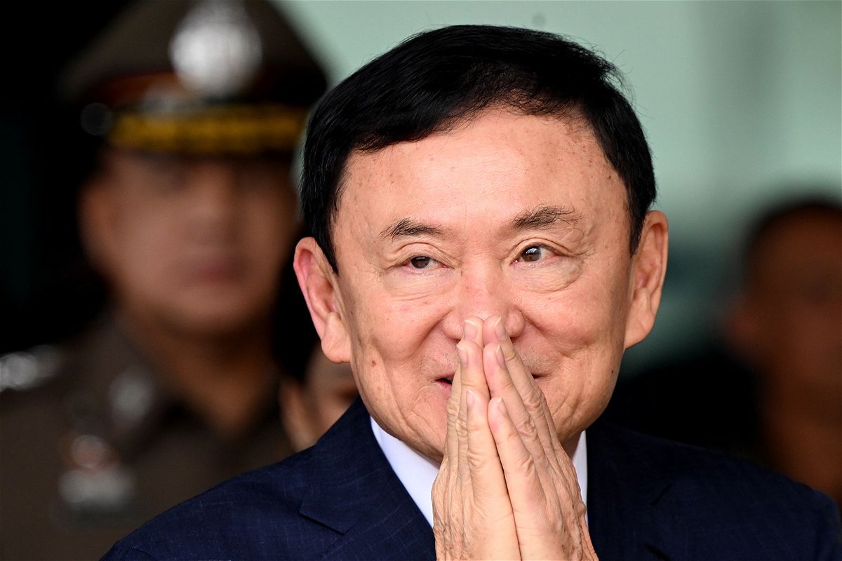 <i>Sirachai Arunrugstichai/Getty Images</i><br/>Former Thai prime minister Thaksin Shinawatra greets supporters as he arrives at Don Mueang International Airport on August 22 in Bangkok