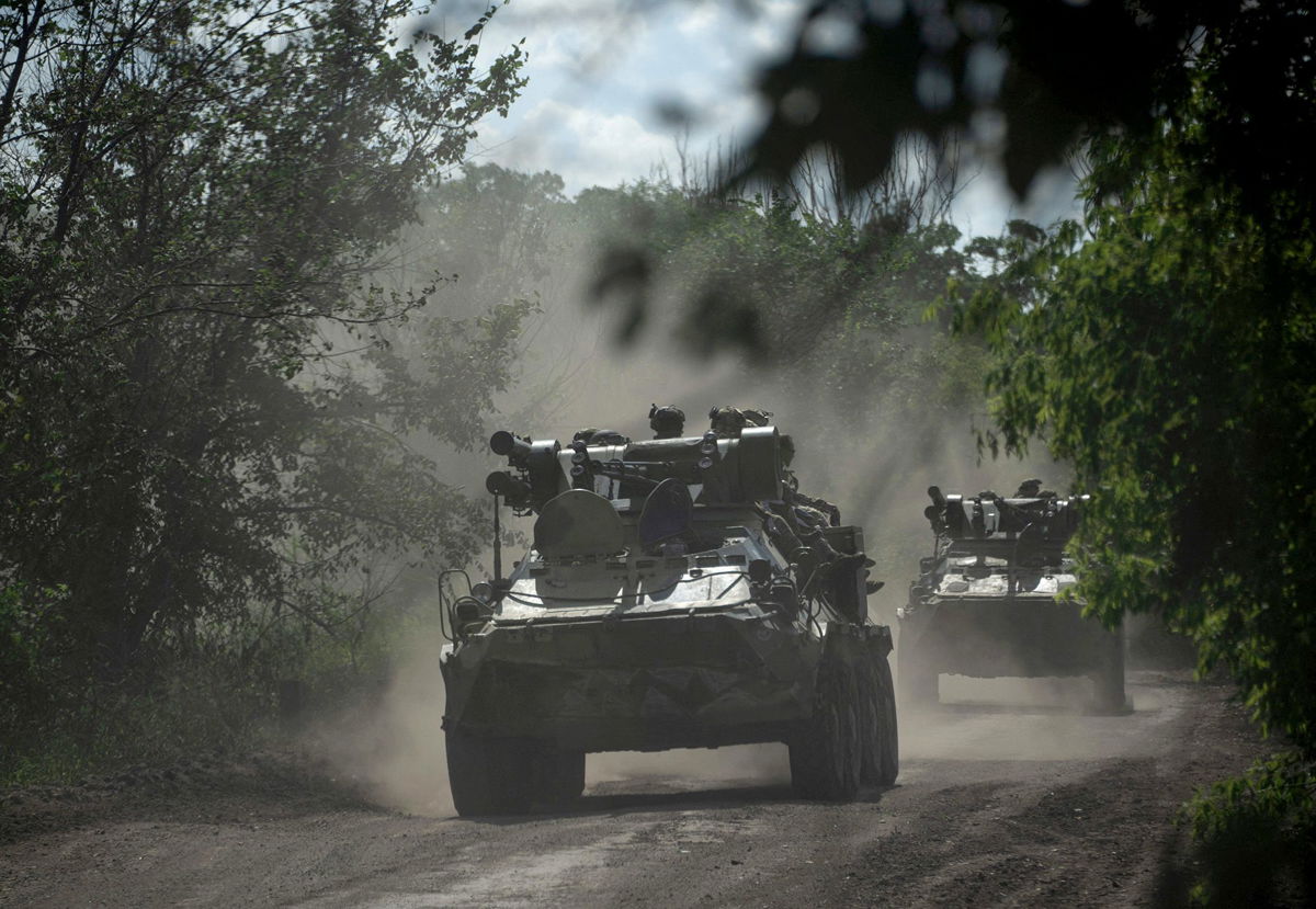 <i>Genya Savilov/AFP/Getty Images</i><br/>Ukrainian servicemen ride on armoured personnel carriers on a road toward Bakhmut on July 1. Fighters who had previously fought in Ukraine for the Russian mercenary group Wagner have returned to the battlefield in the east.